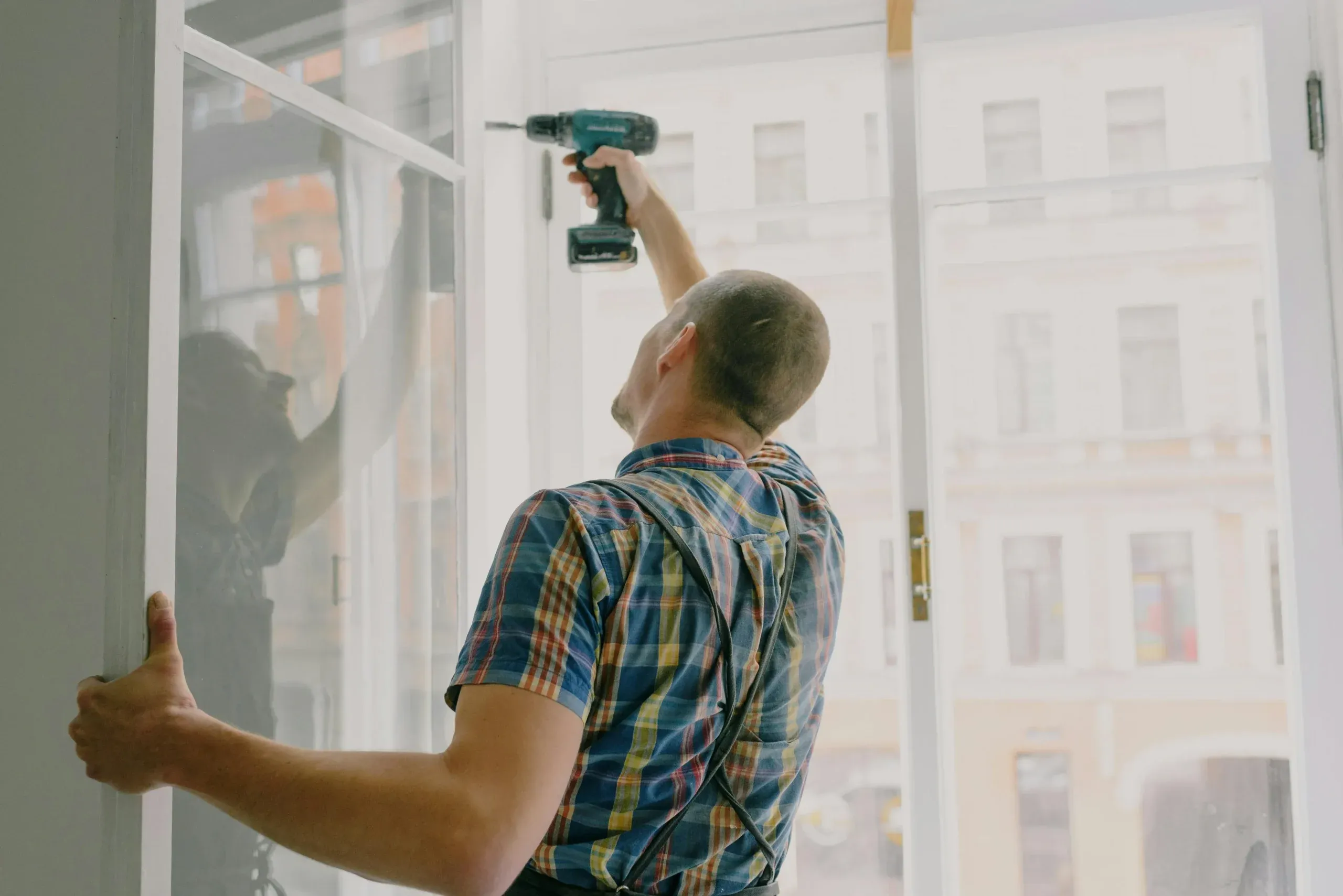Installer preparing a wall for a commercial display mounting project